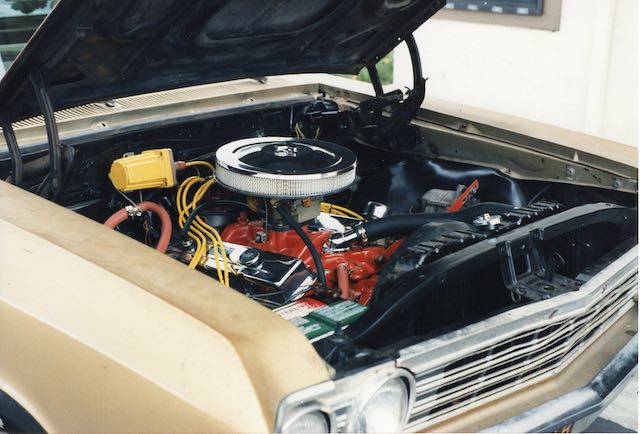 A car engine with wires and plugs attached to it.