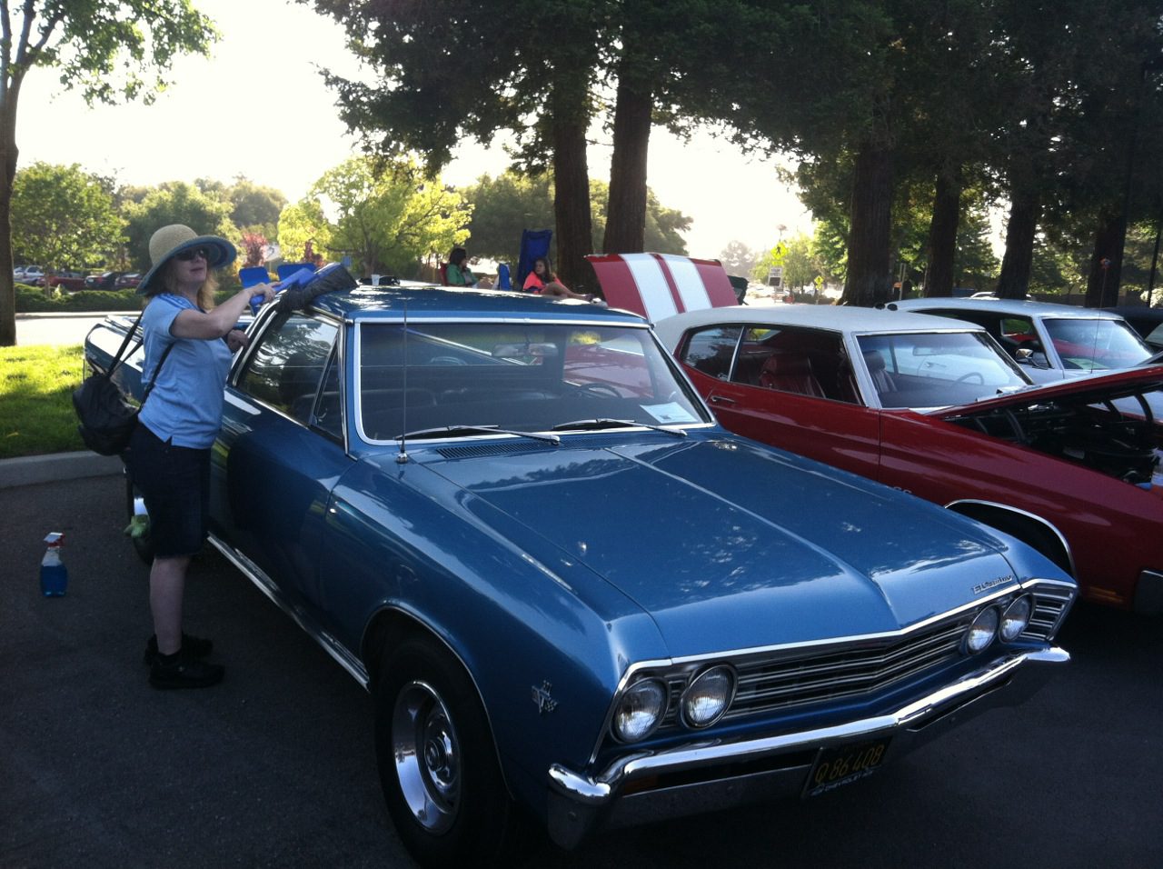 A blue car parked in a parking lot.