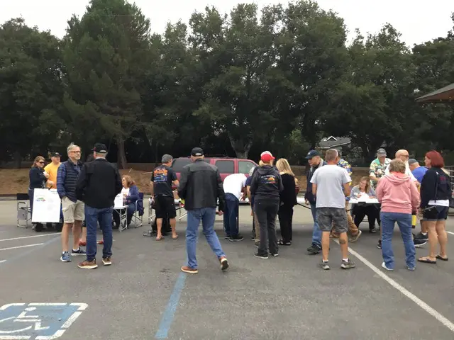 A group of people standing in a parking lot.