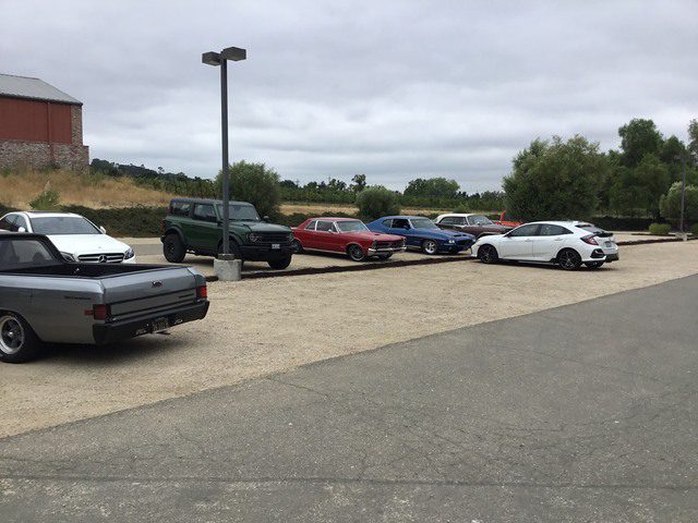 A group of cars parked in a parking lot.
