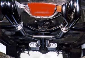 The rear end of a car with a black exhaust pipe.