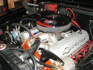 The engine compartment of a black car.