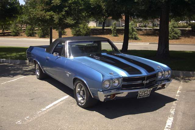 A blue chevrolet chevelle parked in a parking lot.