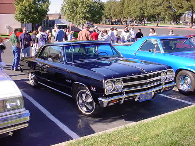 A black chevrolet el camino parked in a parking lot.