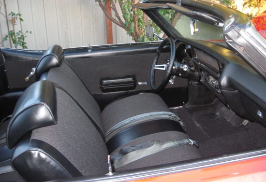 The interior of a classic car with leather seats.
