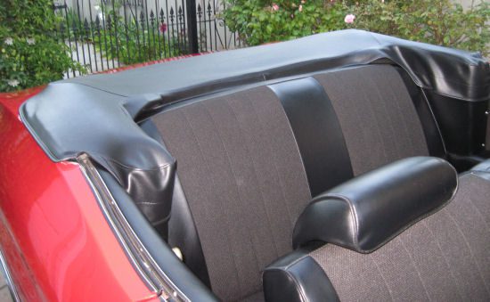 A red convertible with black leather seats.
