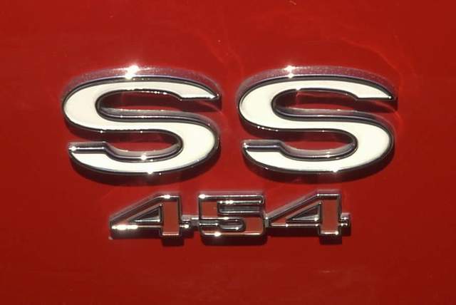 A close up of the emblem on a red car.