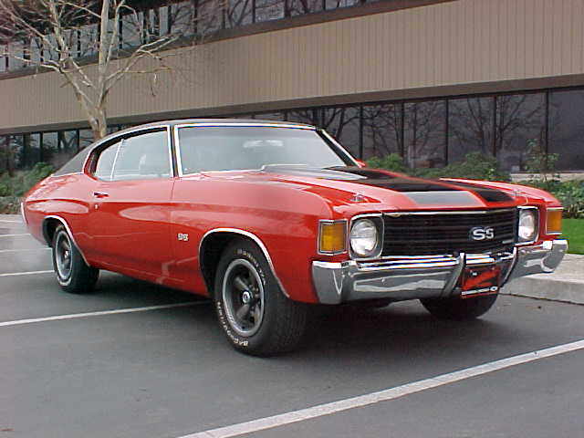 A red chevrolet chevelle parked in a parking lot.